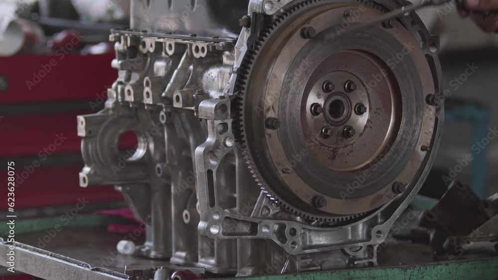 Air Gun Cleaning Repair of Flywheel Gear of Car Engine in Repair Shop Footage. Air Gun Cleaning Repair of Flywheel Gear of Car Engine in Repair Shop Footage.