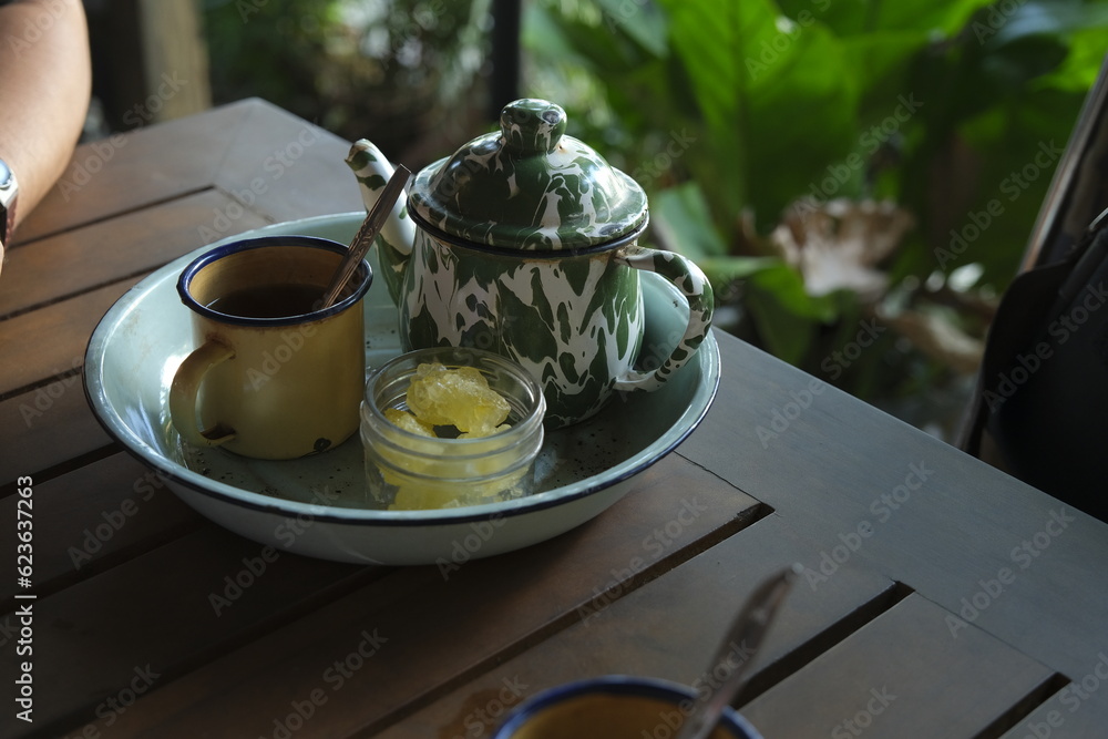 Poci Tea, Teh Poci or tea in enmamel pot oj the table with ature ...