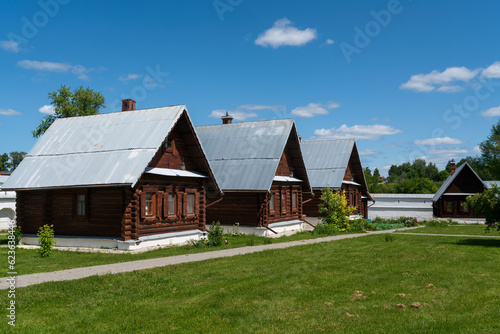 View of wooden residential buildings on the territory of the Holy Intercession Convent on a sunny summer day, Suzdal, Vladimir region, Russia