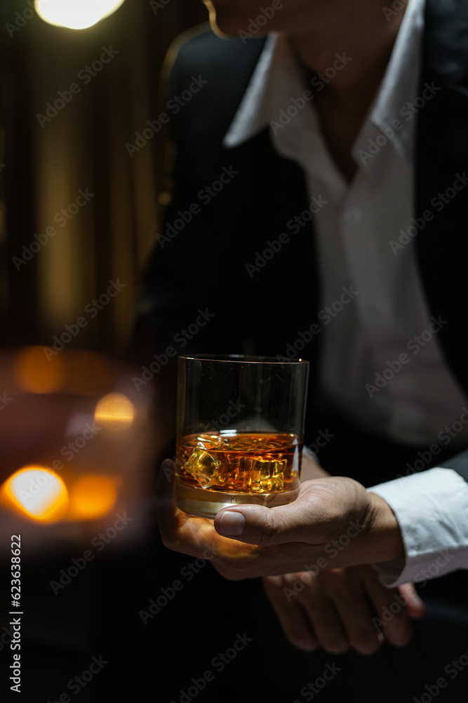 businessmen holding a glass of whiskey businessmen holding a glass of whiskey