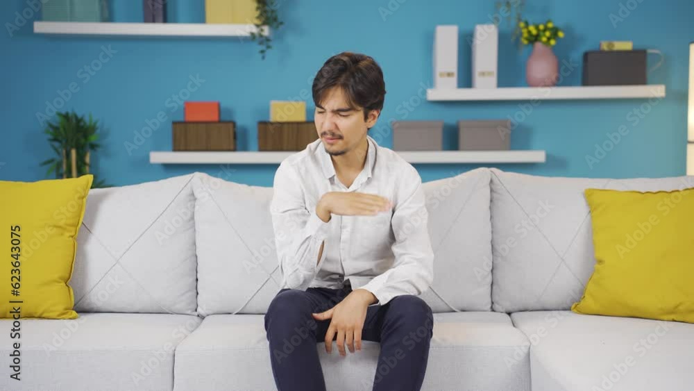 The man who smells bad odor is disturbed and disgusted. The man who smells bad odor is disturbed and disgusted.