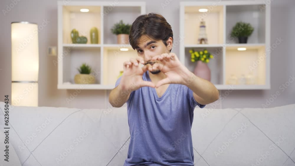 Man making heart sign at camera. Man making heart sign at camera.