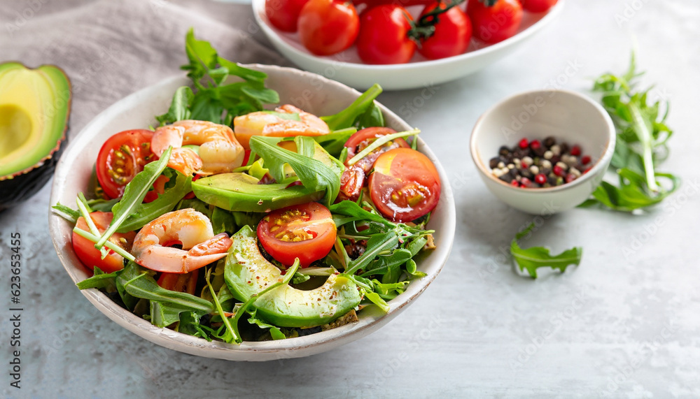 Fresh summer salad with shrimp, avocado and tomato cherry in bowl on light table. Concept of healthy eating. Fresh summer salad with shrimp, avocado and tomato cherry in bowl on light table. Concept of healthy eating.