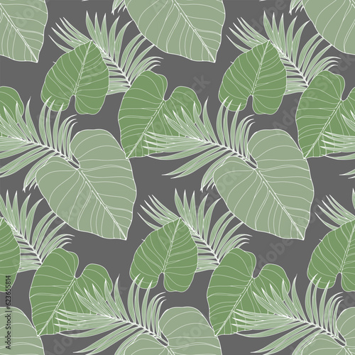 Green tropical seamless pattern with various leaves on a gray background. Pattern for textiles, wrapping paper, wallpapers, covers, decor