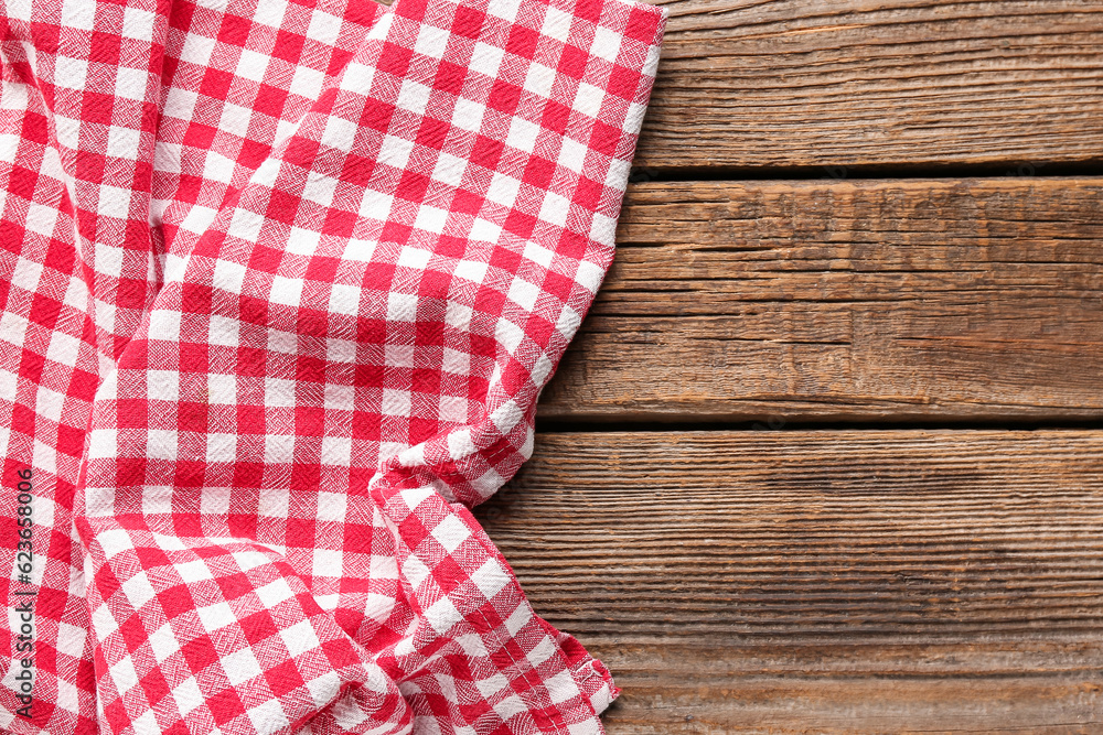 Crumpled red napkin on wooden background Crumpled red napkin on wooden background