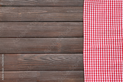Red checkered napkin on dark wooden background