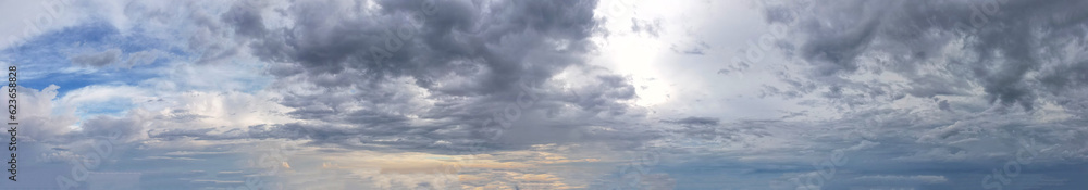 Panorama landscape of white and blue clouds, as the warm glow of the orange light cast a vibrant and magical aura, infusing the scene with a sense of wonder and enchantment.