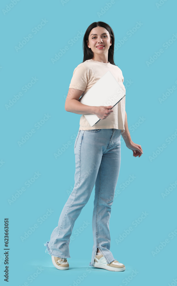 Female programmer with laptop on blue background Female programmer with laptop on blue background