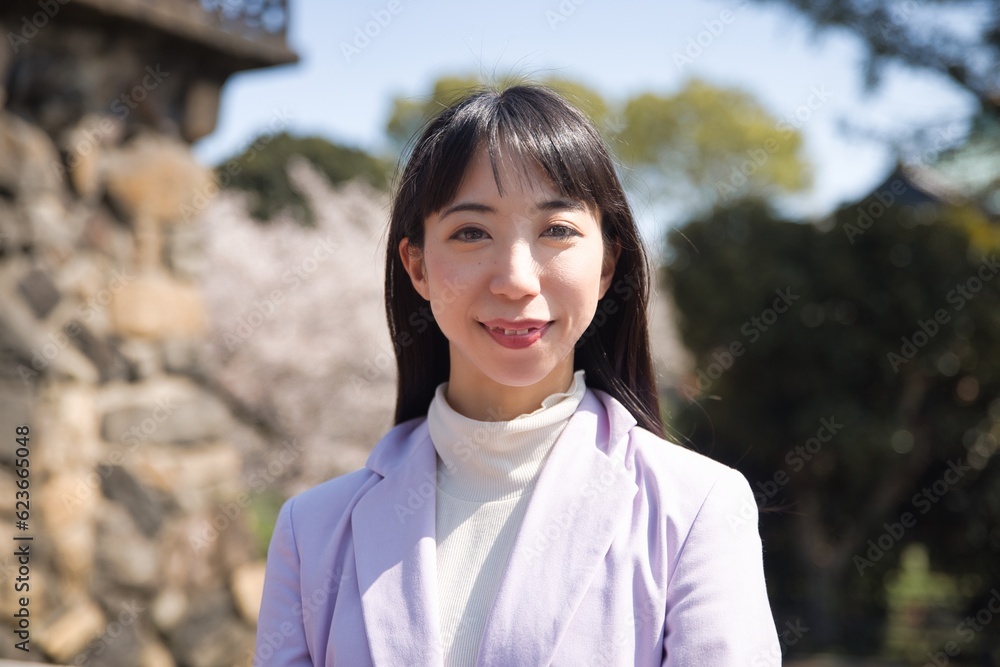 A portrait of Japanese woman behind cherry blossom closeup A portrait of Japanese woman behind cherry blossom closeup