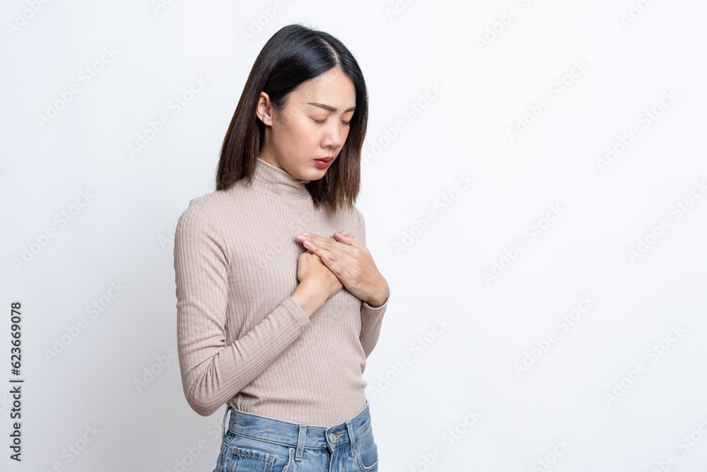 Portrait of sick stressed worried asian woman in checkered shirt clutching chest suffering sudden acute pain, risk of heart attack, breast cancer. indoor studio shot isolated on white background. Portrait of sick stressed worried asian woman in checkered shirt clutching chest suffering sudden acute pain, risk of heart attack, breast cancer. indoor studio shot isolated on white background.