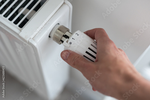 A man turns on the heating