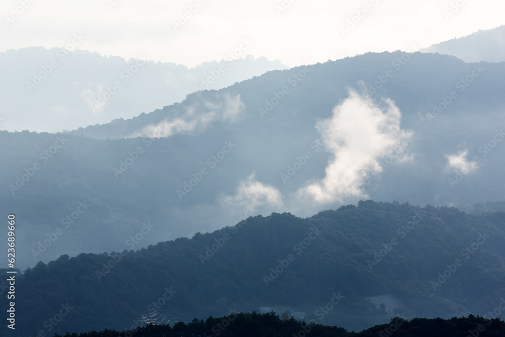 The scenery of blue mountains during sunrise.