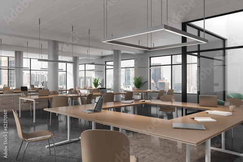 Stylish library interior with shared table and chairs in row, panoramic window