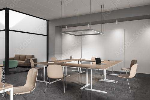 Stylish business interior with desk and chairs, coworking and relax place © ImageFlow