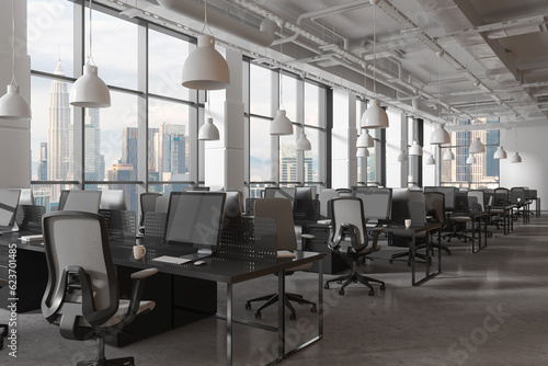 White office interior with pc monitors in row, chairs and panoramic window