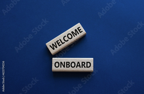 Welcome onboard symbol. Concept words Welcome onboard on wooden blocks. Beautiful deep blue background. Business and Welcome onboard concept. Copy space.