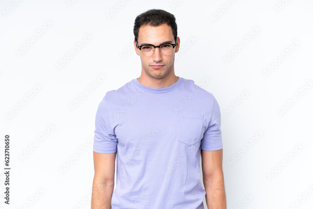 Obraz premium Young caucasian man isolated on white background with sad expression