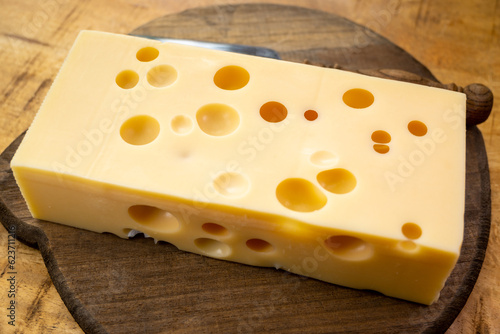 Cheese collection, french hard cheese with holes emmentaler close up