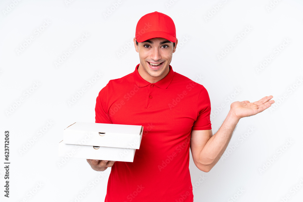 Pizza delivery caucasian man with work uniform picking up pizza boxes isolated on white background with shocked facial expression Pizza delivery caucasian man with work uniform picking up pizza boxes isolated on white background with shocked facial expression
