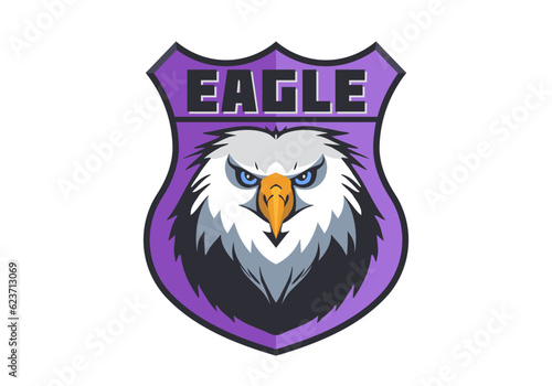 Vector portrait of the head of a formidable eagle on a purple shield. Sticker, icon or emblem. White isolated background.