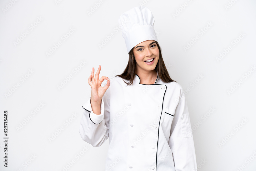 Young Brazilian chef woman isolated on white background showing ok sign with fingers Young Brazilian chef woman isolated on white background showing ok sign with fingers