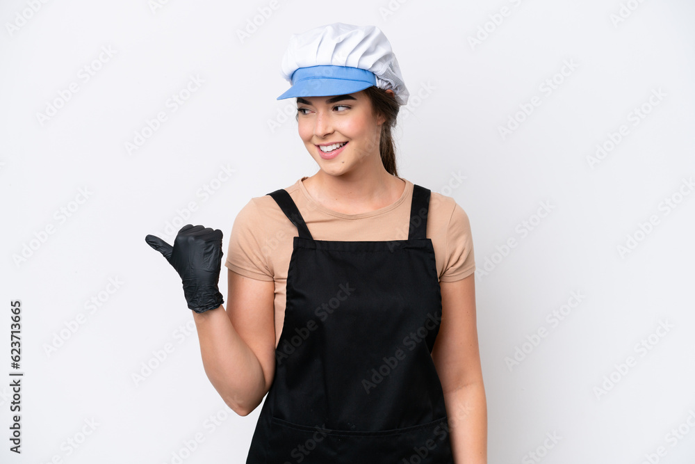 Fishmonger brazilian woman wearing an apron isolated on white background pointing to the side to present a product Fishmonger brazilian woman wearing an apron isolated on white background pointing to the side to present a product