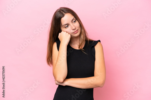 Young caucasian woman isolated on pink background with tired and bored expression