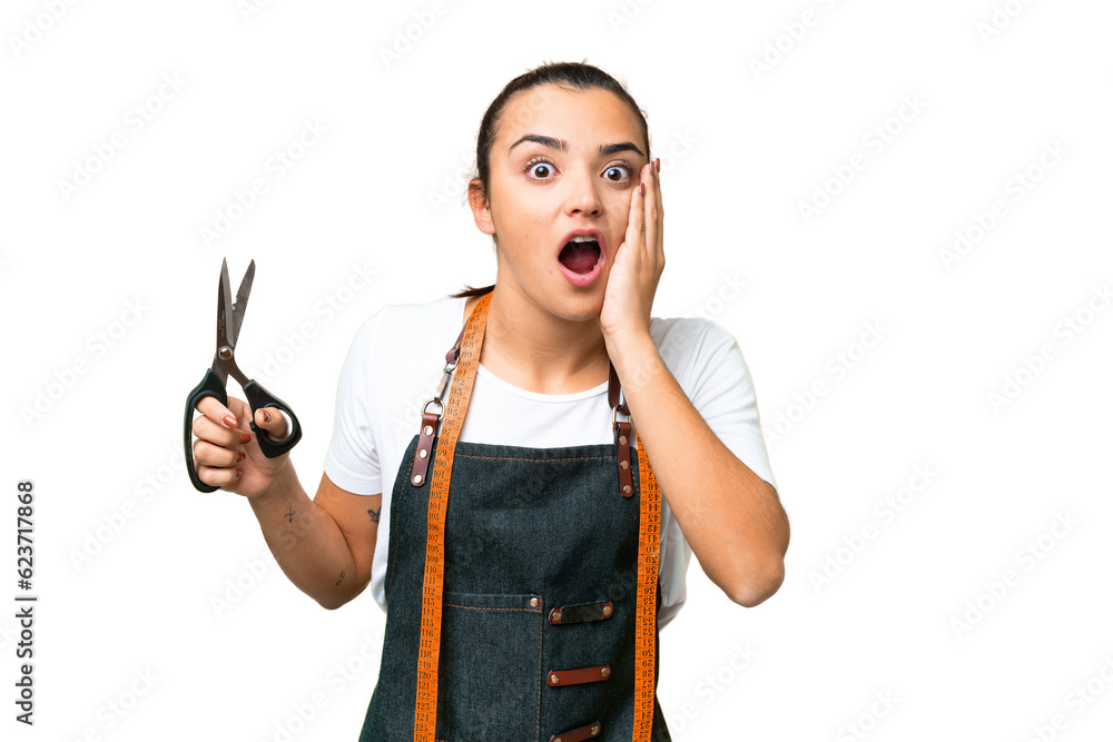 Seamstress woman over isolated chroma key background with surprise and shocked facial expression Seamstress woman over isolated chroma key background with surprise and shocked facial expression