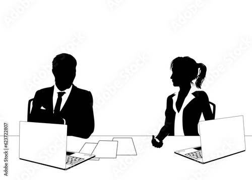 News anchor presenters or business people seated at a desk with laptops in silhouette