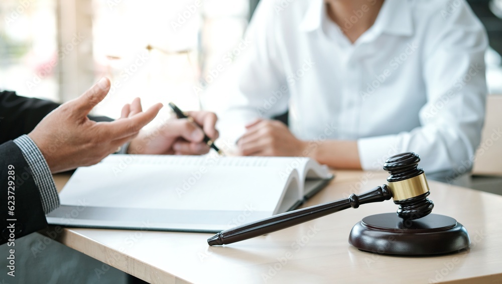 Legal counsel presents to the client a signed contract with gavel and legal law. justice and lawyer concept. Legal counsel presents to the client a signed contract with gavel and legal law. justice and lawyer concept.