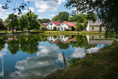 Beautiful Czech countryside with cottages reflecting on the surface of the pond
