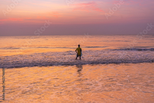 A young Fisherman prepares on cast the sunrise in Thailand.