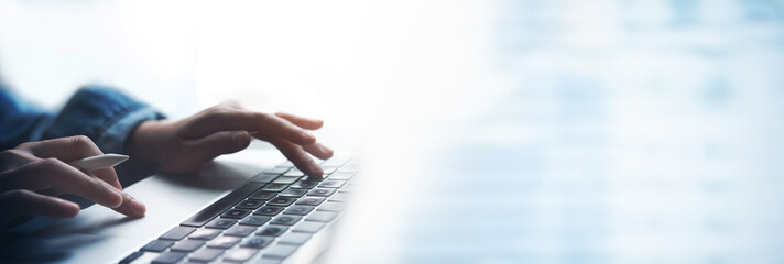 Business woman hands typing on laptop computer keyboard, surfing the internet at the office with copy space for web banner, Woman worker and business concept.