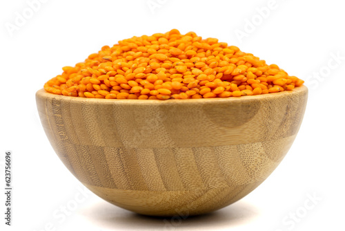 Red lentils isolated on white background. Raw red lentils in wooden bowl