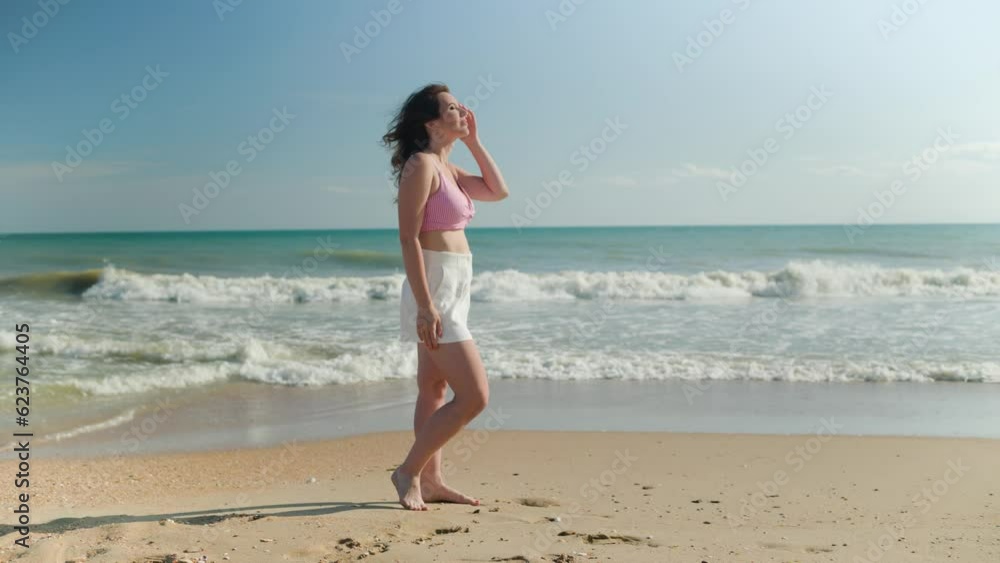 Beautiful adult brunette woman on a sandy seashore Beautiful adult brunette woman on a sandy seashore