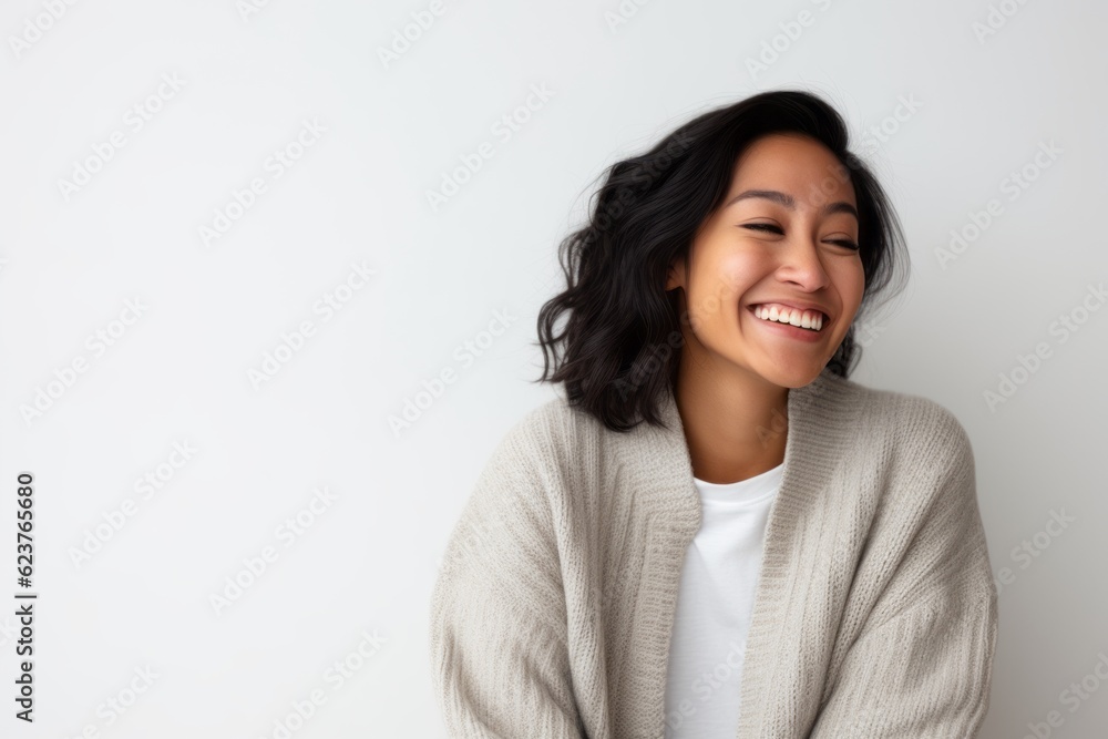 Portrait of happy young Asian woman laughing and looking at copy space Portrait of happy young Asian woman laughing and looking at copy space