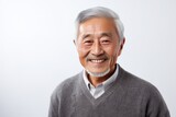 Portrait of a senior asian man smiling on white background.