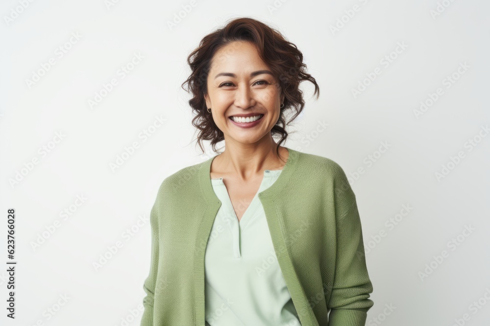 Portrait of a smiling businesswoman standing over white background, looking at camera