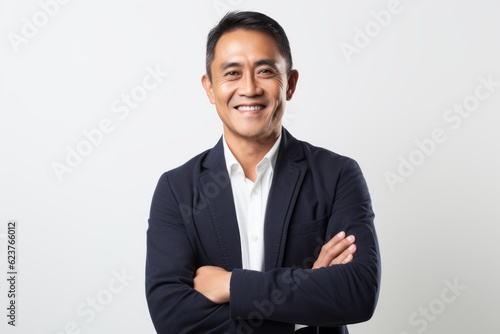 Portrait of a smiling young asian business man on white background