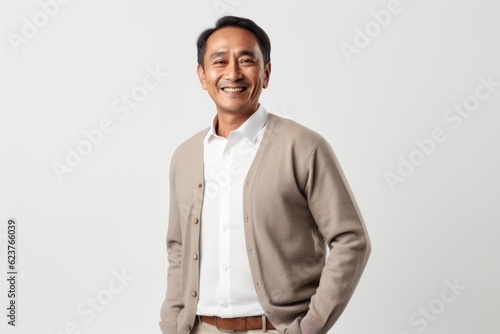 Portrait of a smiling asian man standing over white background.