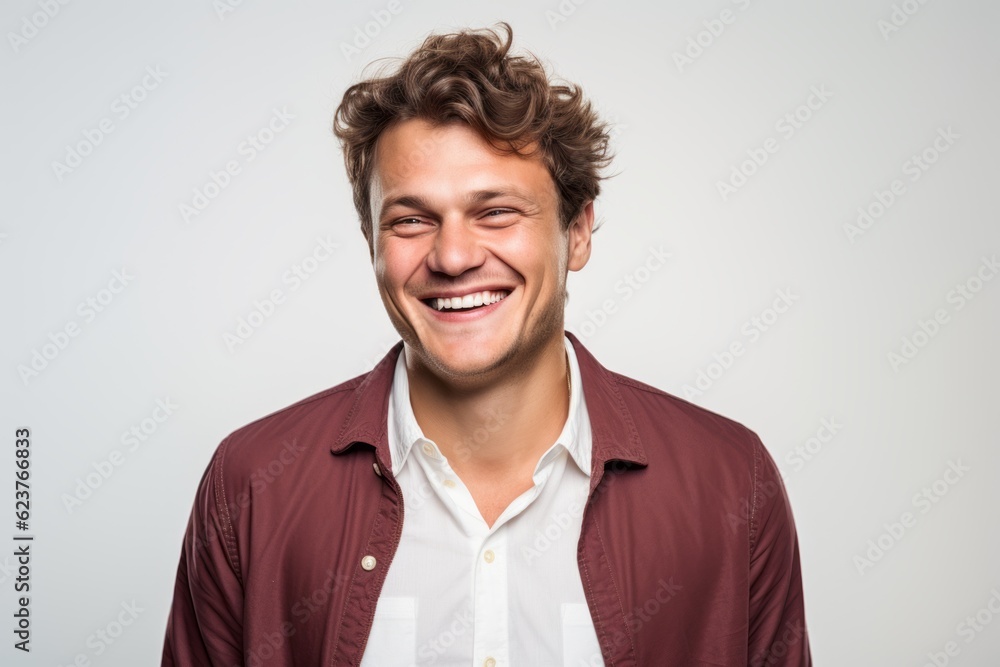 Portrait of a happy young man laughing isolated on a white background Portrait of a happy young man laughing isolated on a white background