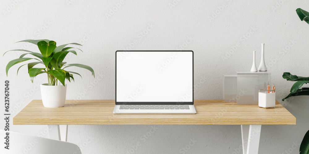 Laptop in a minimalist and modern desk with plants Laptop in a minimalist and modern desk with plants