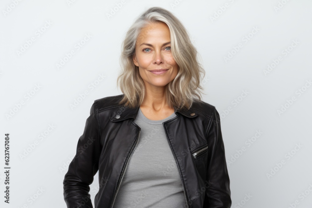 Portrait of a beautiful middle-aged woman in a black leather jacket against a white background Portrait of a beautiful middle-aged woman in a black leather jacket against a white background
