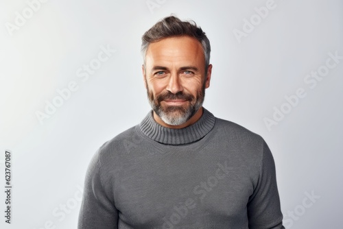Handsome middle-aged man in a gray sweater on a white background