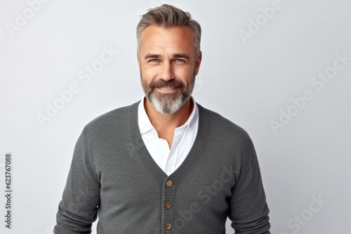 Portrait of handsome mature man with grey hair and beard looking at camera