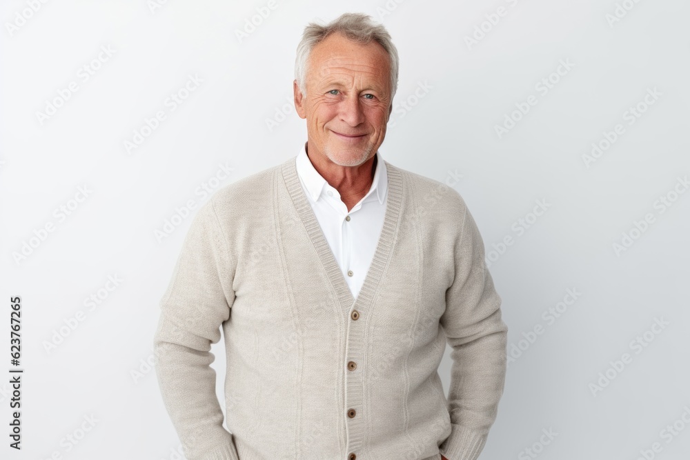 Portrait of handsome senior man looking at camera and smiling while standing against white background Portrait of handsome senior man looking at camera and smiling while standing against white background