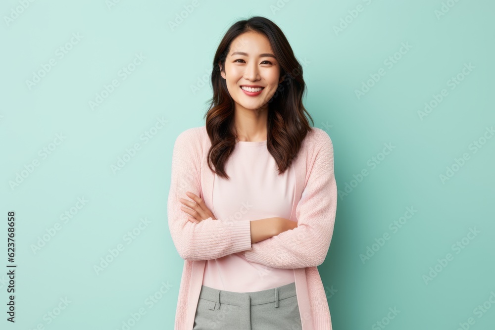 Portrait of a smiling young asian woman standing with arms crossed Portrait of a smiling young asian woman standing with arms crossed