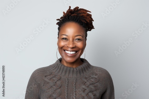 Portrait of a beautiful african american woman smiling over gray background