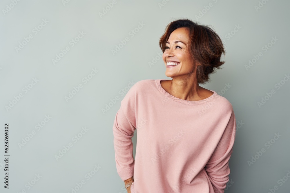 Fototapeta premium Portrait of smiling african american woman standing against grey background