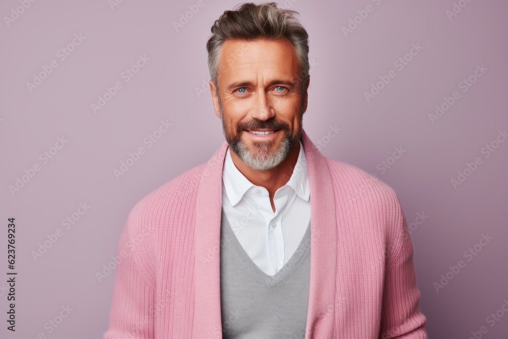 Portrait of a smiling mature man in a pink jacket on a purple background Portrait of a smiling mature man in a pink jacket on a purple background
